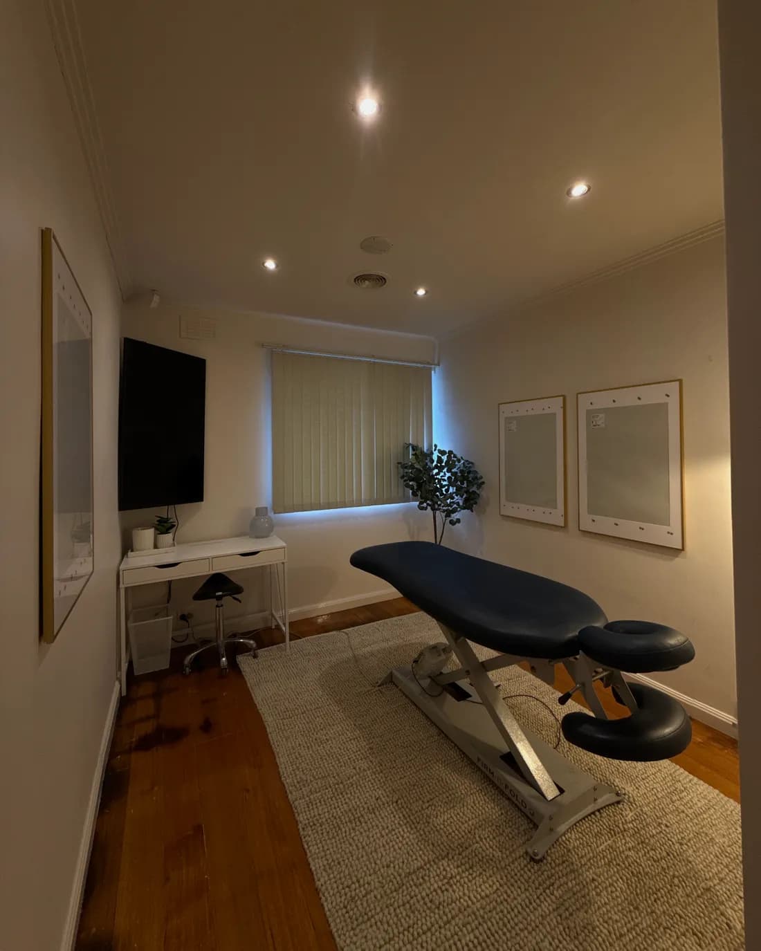 Consulting room with a desk and chiropractic table at Advanced Chiropractic in Mulgrave